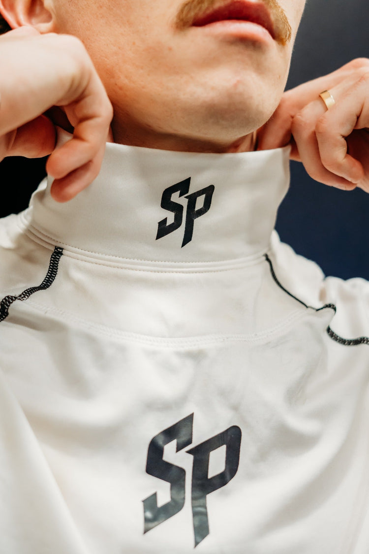 Close-up of white Southern Puck neck guard collar with black SP logo